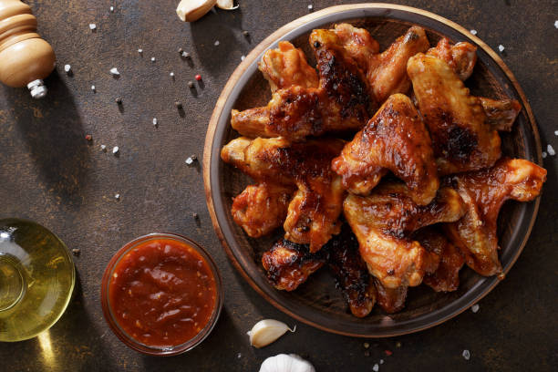 istock Barbecued chicken wings with bbq sauce on the plate. 939746352