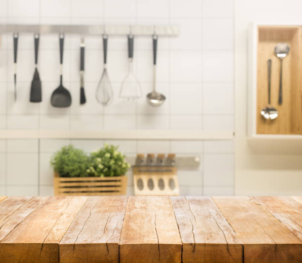 istock Wood table top on blur kitchen room background 939749740