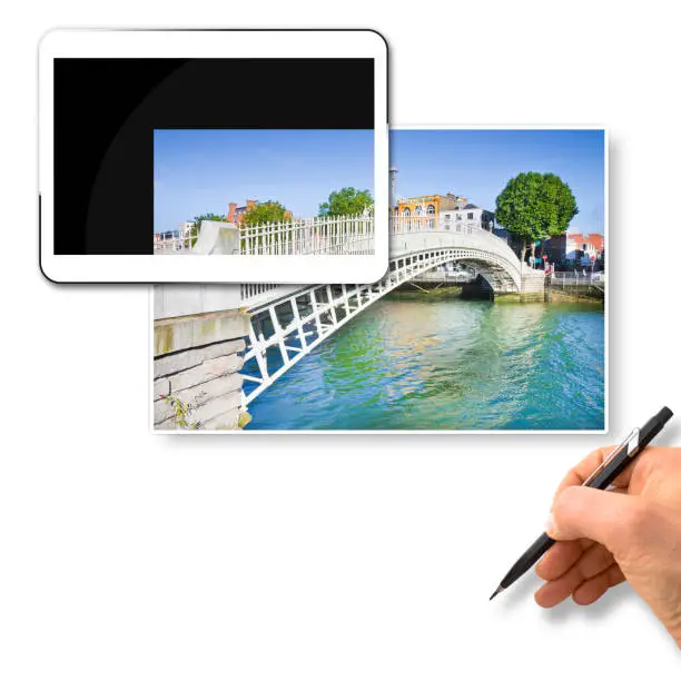 Photo of The most famous bridge in Dublin called -Half penny bridge- due to the toll charged for the passage - Concept image with 3D render of a digital tablet and hand writing on blank space