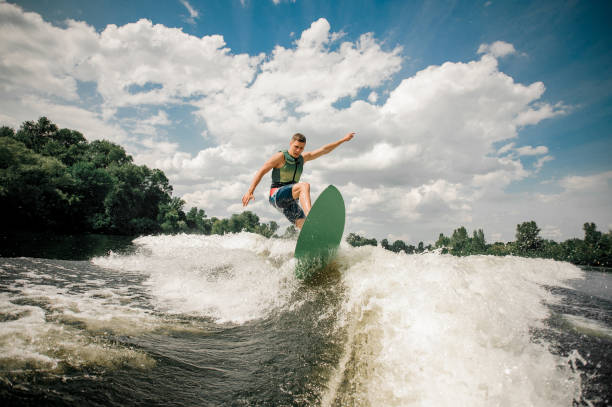 istock healthy male rides the waves in a summer river 939758100