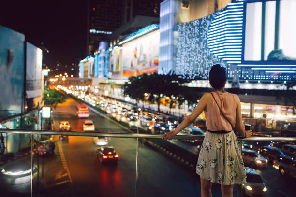 tourist woman enjoys the view at siam square in bangkok, thailand - siam square imagens e fotografias de stock