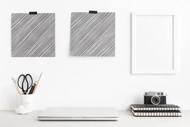 Photo of Minimal workspace desk with laptop computer, stationery and camera. Mock up.