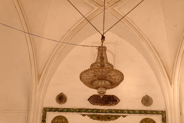 istock Ancient chandelier on the ceiling decorated with arches 939772256