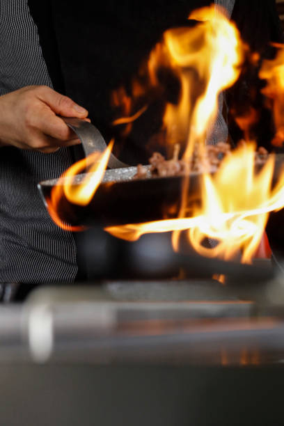 istock Professional Chef Cooks Flambe Style. 939776374