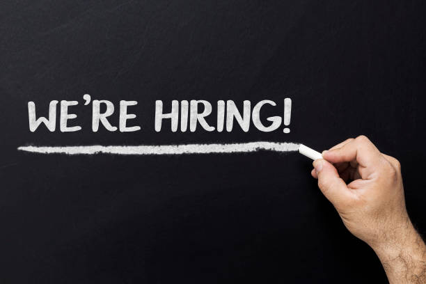 istock Businessman writing We're hiring on blackboard 939780600