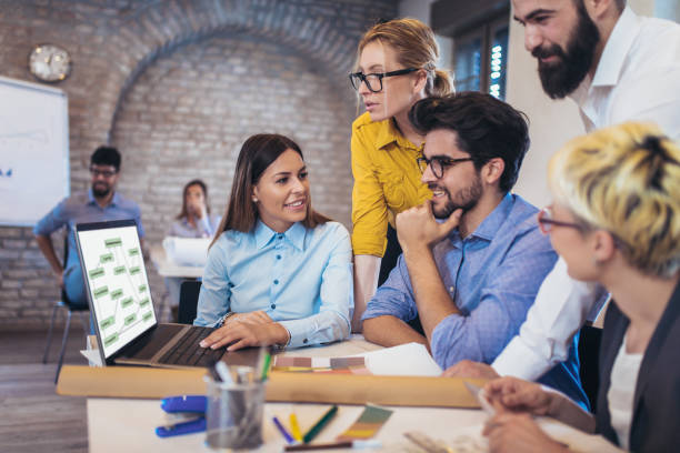 istock Business people working in office together. Team work in office. 939784076