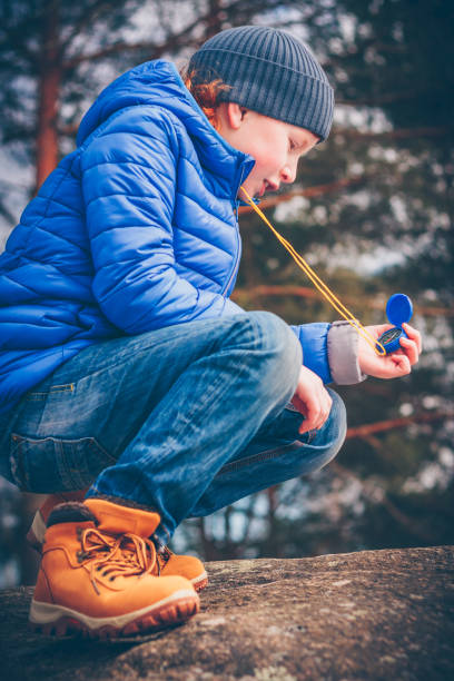 istock The young red-headed pioneer is making his way through the compass 939784678