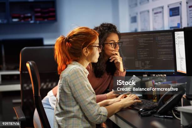 Two Female Programmers Working On New Projectthey Working Late At Night At The Office Stock Photo - Download Image Now