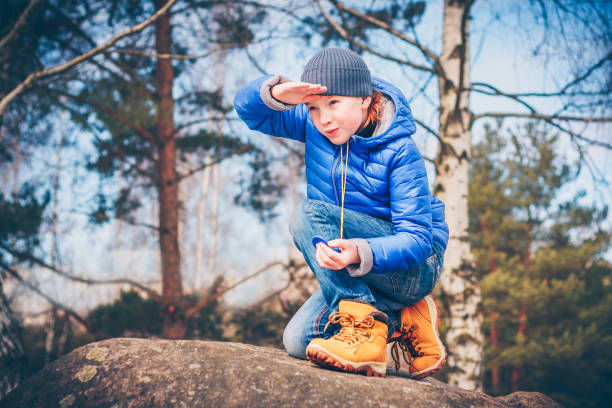 istock A young red-haired pathfinder looking for adventure making his way through the rocks 939787796