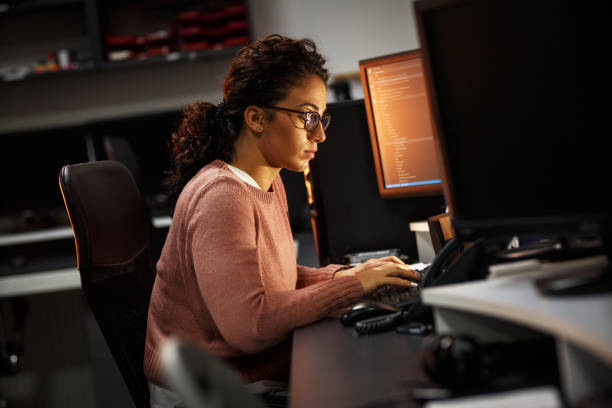 istock Female programmer working on new project.She working late at night in her office. 939787918