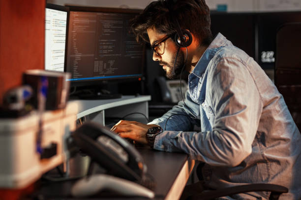 istock Male programmer working on new project.He working late at night at the office. 939788242
