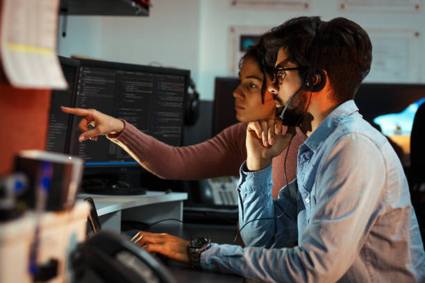 istock Two programmers working on new project.They working late at night at the office. 939788250
