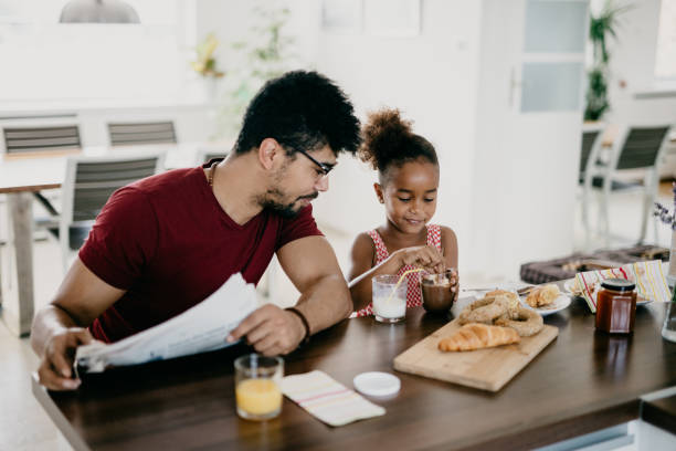 istock Cute little girl deeps her breakfast in chocolate cream 939788458