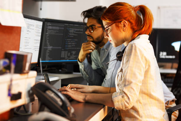 istock Two programmers working on new project.They working late at night at the office. 939790644