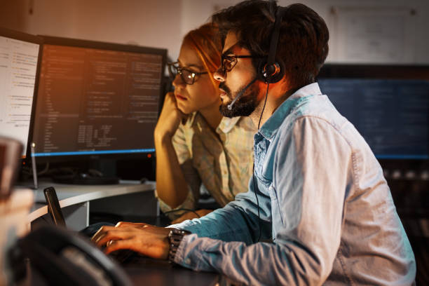 istock Two programmers working on new project.They working late at night at the office. 939790650
