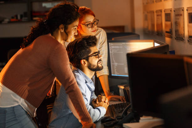istock Team of programmers working on new project.They working late at night at the office. 939790734