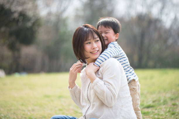 istock Mother and child relaxing and playing in park 939790890
