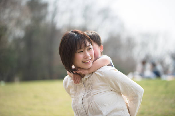 istock Mother and child relaxing and playing in park 939791030