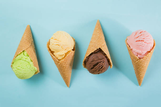 istock Selection of colorful ice cream scoops on blue background 939791216