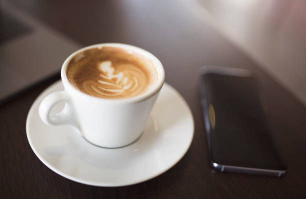 istock Coffee and smartphone on wooden table 939791686