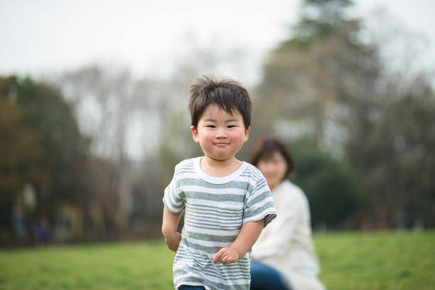 istock Mother and child relaxing and playing in park 939791768