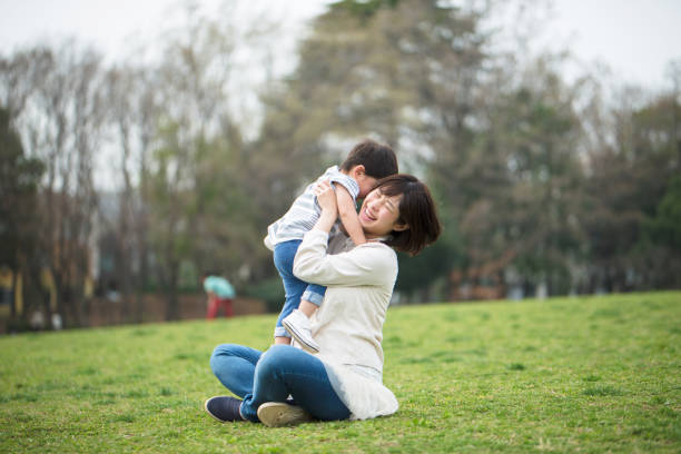 istock Mother and child relaxing and playing in park 939791846
