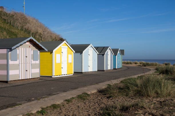 istock Beach huts at Pakefield, Suffolk, England, against a blue sky 939791930