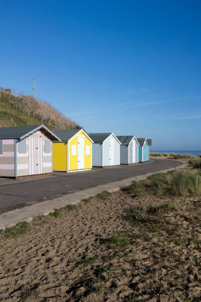 istock Beach huts at Pakefield, Suffolk, England, against a blue sky 939792424