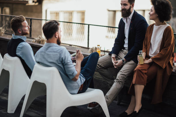 istock Attractive group of business people relaxing during lunch break 939800178