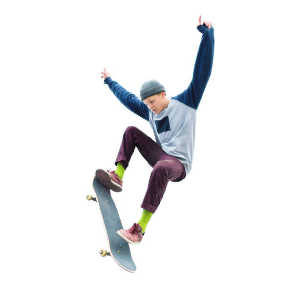 A teenage boy in a hat and a sweatshirt jumping with a skateboard does a trick on an isolated white background. The cut out character the preparation stock photo