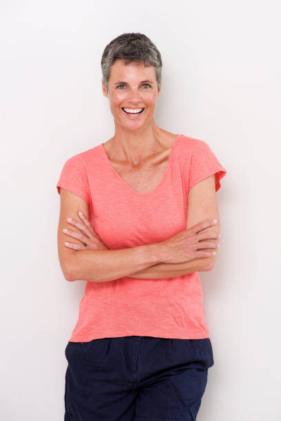 istock confident older woman smiling against white background 939808878
