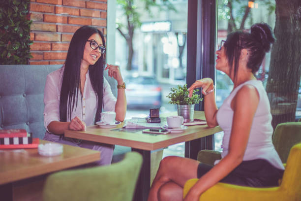 istock Best friends drinking coffee and relaxing in the cafe 939818068