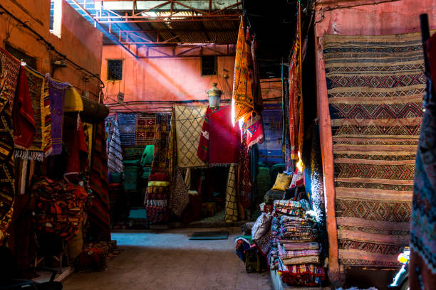 istock Sunlight ray in a Souk of Marrakesh with carpets 939819874