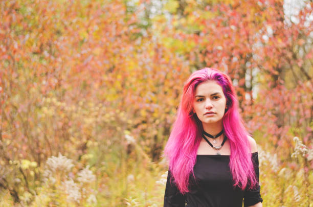 istock Young witch in black dress is making magic witchcraft in the forest 939822452
