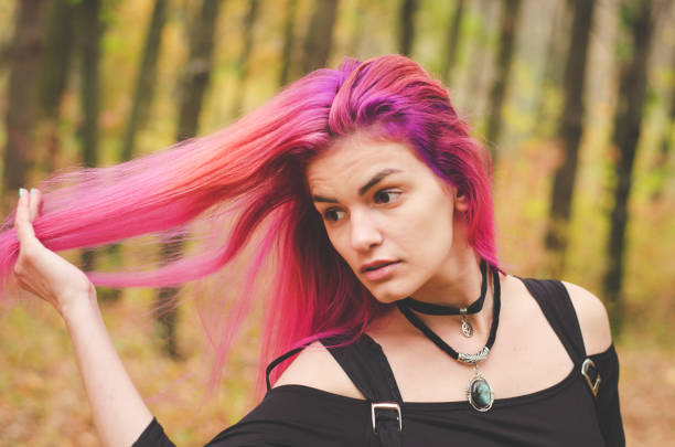 istock Young witch in black dress is making magic witchcraft in the forest 939822478
