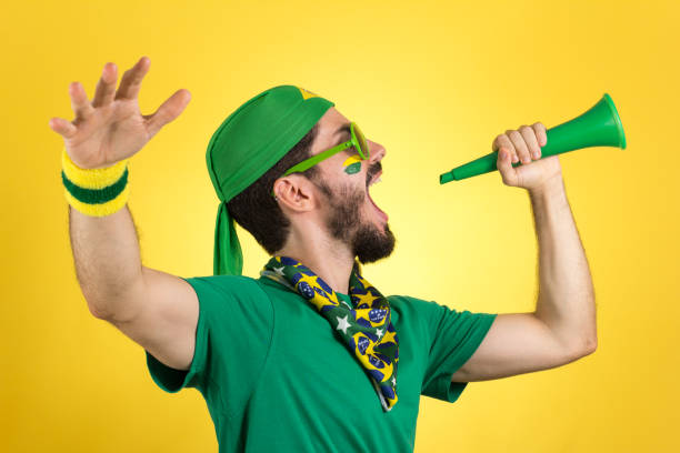 brazilian supporter of national football team is celebrating, cheering. male fan. - fan sport football male imagens e fotografias de stock