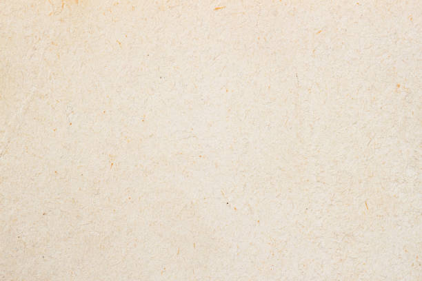 istock Texture of light ecological cream paper, background for design with copy space text or image. Recyclable material, has small inclusions of cellulose 939827382