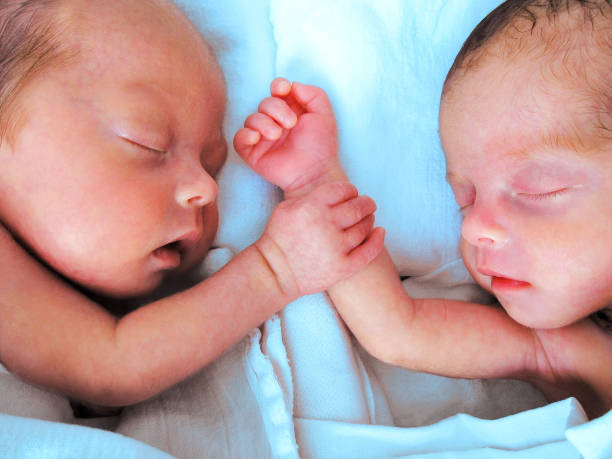 istock Newborn Premature Twins holding hands 939829948