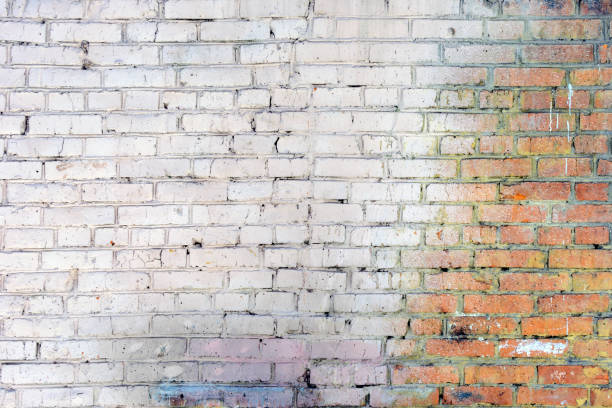 istock The old brick wall is dirty. Empty background of smooth rows of stones. 939830020
