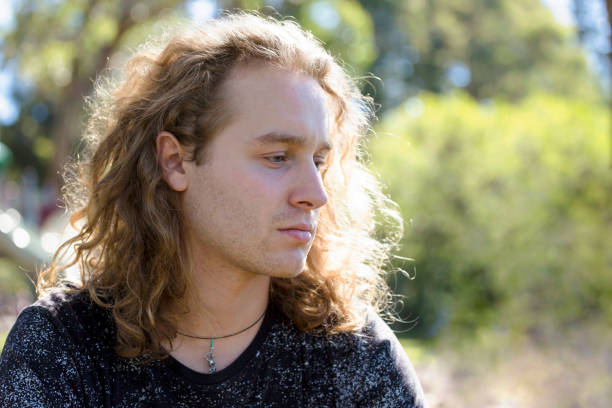 istock Portrait of pensive young man, background with copy space 939833292