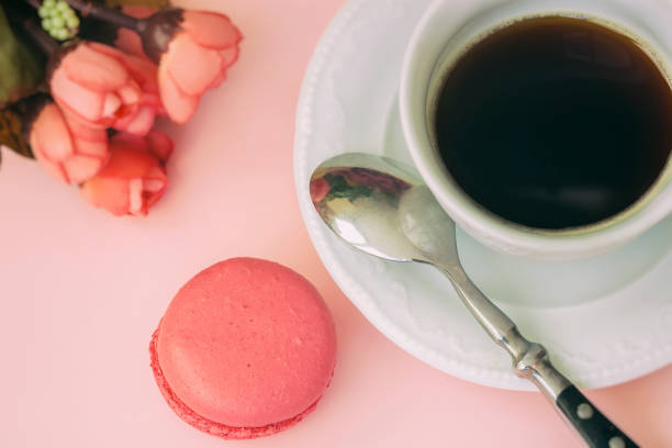 istock Pink macaron, macaroon and cup of coffee, spring flowers, tender pastel background. Romantic morning Dessert, gift, present for beloved 939833444
