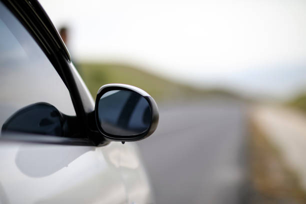 Purple car in the rearview mirror on the highway in Malmö Sweden.