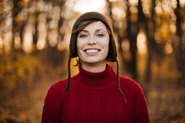 Beautiful woman with red hair and blue outfit laughs outside