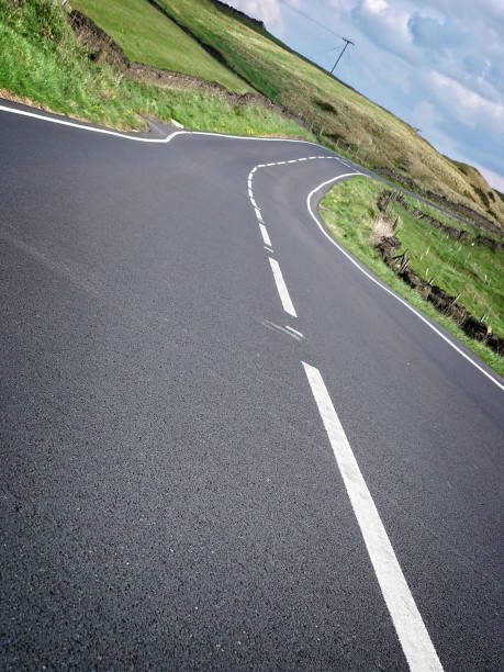 istock Empty country road and green fields, countryside 939840754