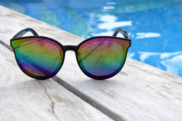 istock Sunglasses on a wooden resort poolside 939841350