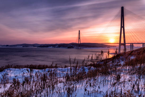 istock Winter sunset view of long cable-stayed bridge 939841802