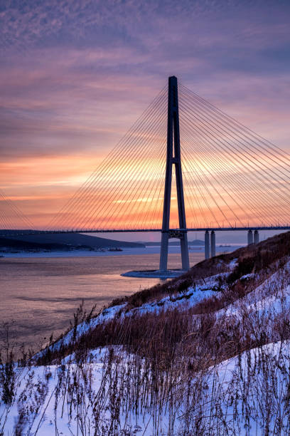 istock Winter sunset view of long cable-stayed bridge 939841834