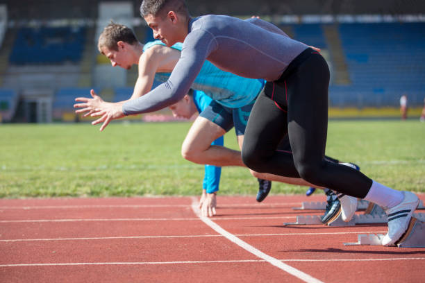 istock Athletes at the sprint start line in track and field 939842340
