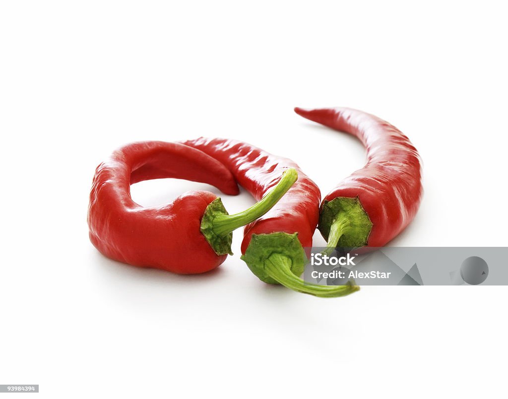 three hot chilli pepers three hot chilli pepers on white background Cayenne Powder Stock Photo