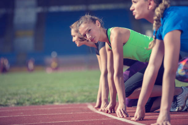 istock Women ready to race on track field 939845810